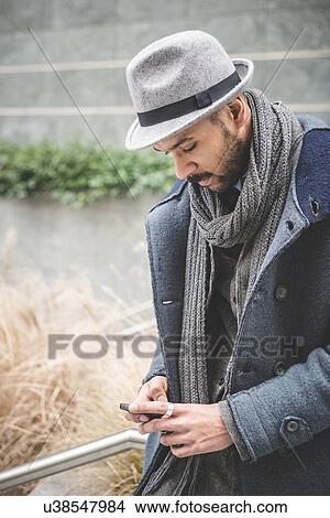 Mid adult businessman standing on stairway reading text message View Large Photo Image Picture - Mid adult businessman standing on stairway reading text message. Fotosearch