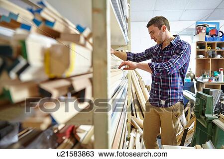 Mid adult man searching stockroom shelves in picture framers workshop View Large Photo Image Stock Image - Mid adult man searching stockroom shelves in picture framers workshop. Fotosearch