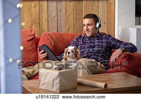 Mid adult man using digital tablet in picture framers showroom View Large Photo Image Stock Image - Mid adult man using digital tablet in picture framers showroom. Fotosearch