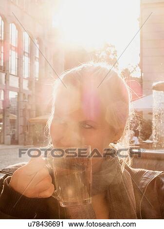 "Mid adult woman enjoying drink, outdoors, Leipzig, Germany" View Large Photo Image Stock Image - "Mid adult woman enjoying drink, outdoors, Leipzig, Germany". Fotosearch