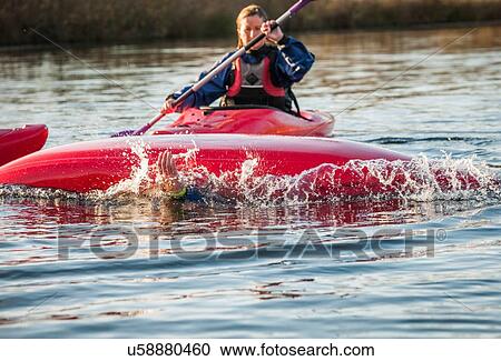 Mid adult woman kayaking View Large Photo Image Stock Image - Mid adult woman kayaking. Fotosearch