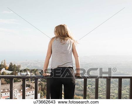 "Mid adult woman standing on balcony, looking at view, Mijas, Andalucia, Spain" View Large Photo Image Stock Image - "Mid adult woman standing on balcony, looking at view, Mijas, Andalucia, Spain". Fotosearch