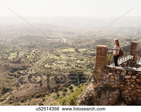 "Mid adult woman standing on balcony, looking at view, Mijas, Andalucia, Spain" View Large Photo Image Stock Photograph - "Mid adult woman standing on balcony, looking at view, Mijas, Andalucia, Spain". Fotosearch