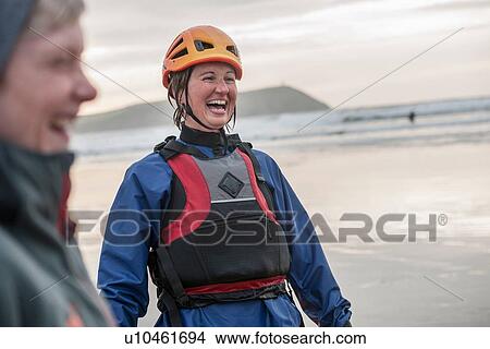 "Mid adult woman wearing helmet and life jacket, laughing" View Large Photo Image Picture - "Mid adult woman wearing helmet and life jacket, laughing". Fotosearch