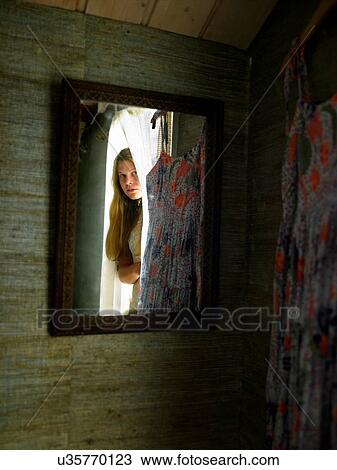 Mirror reflection of teenage girl peering from bedroom doorway View Large Photo Image Stock Image - Mirror reflection of teenage girl peering from bedroom doorway. Fotosearch