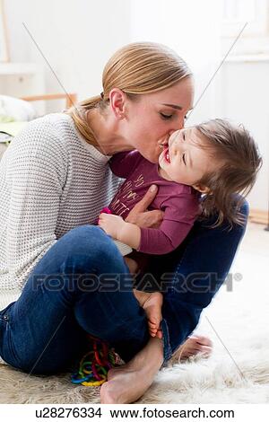 "Mother and baby boy, at home, playing together" View Large Photo Image Picture - "Mother and baby boy, at home, playing together". Fotosearch