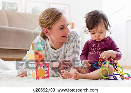 "Mother and baby boy, at home, playing together" View Large Photo Image Stock Image - "Mother and baby boy, at home, playing together". Fotosearch