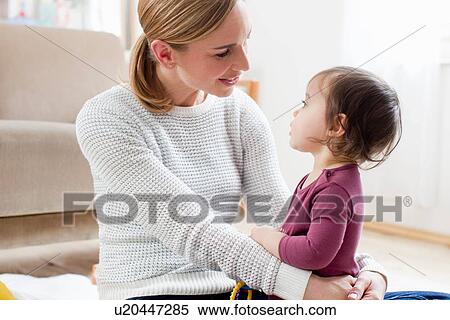 Mother and baby boy sitting face to face View Large Photo Image Stock Photography - Mother and baby boy sitting face to face. Fotosearch