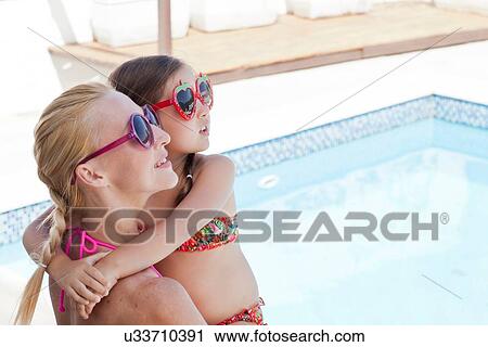 "Mother and daughter, by side of pool, looking up" View Large Photo Image Stock Image - "Mother and daughter, by side of pool, looking up". Fotosearch