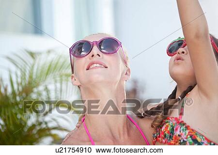"Mother and daughter looking up, daughter pointing" View Large Photo Image Stock Image - "Mother and daughter looking up, daughter pointing". Fotosearch