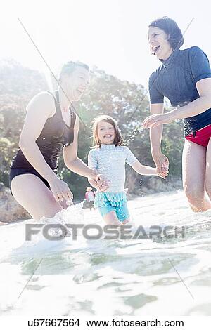 Picture - "Mother and daughter, with friend, by the seaside". Fotosearch
