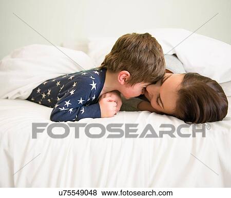 Mother and son playing together in bed View Large Photo Image Stock Photo - Mother and son playing together in bed. Fotosearch