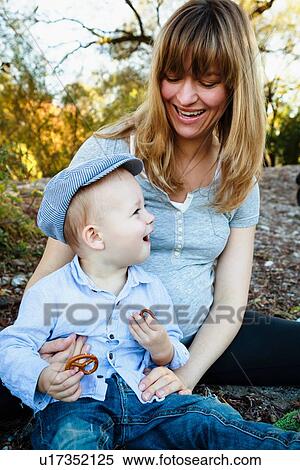"Mother and son sitting together, outdoors, in rural setting" View Large Photo Image Stock Photography - "Mother and son sitting together, outdoors, in rural setting". Fotosearch