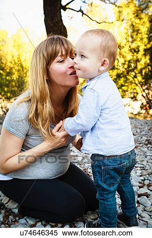 "Mother giving son kiss, outdoors" View Large Photo Image Stock Photography - "Mother giving son kiss, outdoors". Fotosearch