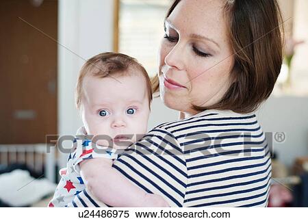 Stock Photography - Mother holding baby daughter. Fotosearch