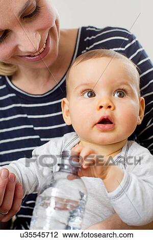Mother holding baby girl View Large Photo Image Stock Image - Mother holding baby girl. Fotosearch