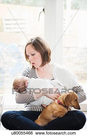 Stock Photograph - Mother holding baby girl. Fotosearch