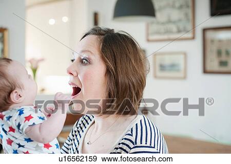 Mother playing with baby daughter View Large Photo Image Stock Photo - Mother playing with baby daughter. Fotosearch