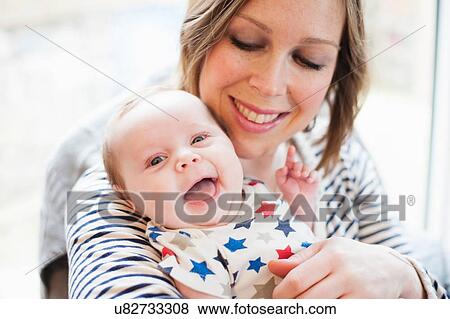 Mother tickling baby daughter View Large Photo Image Stock Photo - Mother tickling baby daughter. Fotosearch