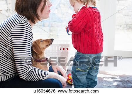 Mother with her son and pet dog View Large Photo Image Stock Photograph - Mother with her son and pet dog. Fotosearch