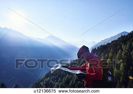"Mountain biker holding map, Valais, Switzerland" View Large Photo Image Stock Photography - "Mountain biker holding map, Valais, Switzerland". Fotosearch