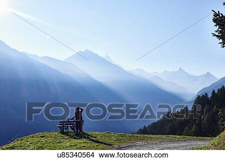 "Mountain biker in mountains, Valais, Switzerland" View Large Photo Image Picture - "Mountain biker in mountains, Valais, Switzerland". Fotosearch