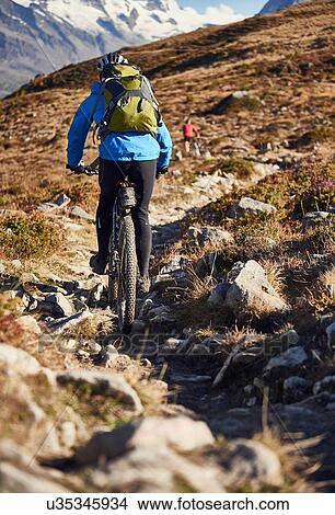 "Mountain biker, Valais, Switzerland" View Large Photo Image Picture - "Mountain biker, Valais, Switzerland". Fotosearch