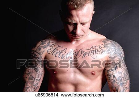 Muscular young man with tattoos View Large Photo Image Picture - Muscular young man with tattoos. Fotosearch