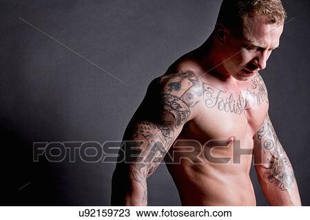 Muscular young man with tattoos View Large Photo Image Stock Image - Muscular young man with tattoos. Fotosearch