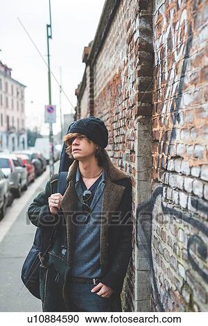 "Musician walking along city wall, Milan, Italy" View Large Photo Image Stock Image - "Musician walking along city wall, Milan, Italy". Fotosearch