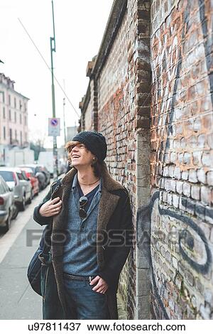 "Musician walking along city wall, Milan, Italy" View Large Photo Image Stock Photo - "Musician walking along city wall, Milan, Italy". Fotosearch