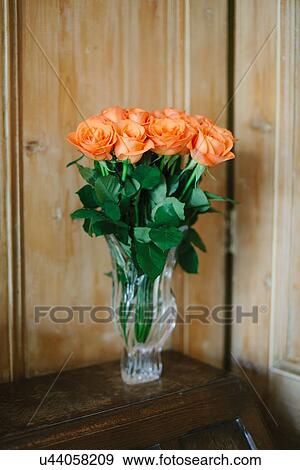 Stock Photo - Orange roses in vase. Fotosearch