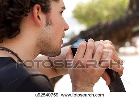 "Over the shoulder view of young man using smartwatch, Copacabana, Rio De Janeiro, Brazil" View Large Photo Image Stock Photo - "Over the shoulder view of young man using smartwatch, Copacabana, Rio De Janeiro, Brazil". Fotosearch