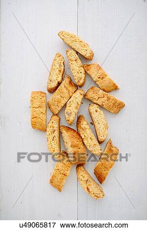 Stock Photo - Overhead view of almond cantucci biscuits on tablecloth. Fotosearch