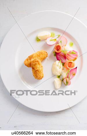 Overhead view of plate of fish sticks and radishes View Large Photo Image Picture - Overhead view of plate of fish sticks and radishes. Fotosearch