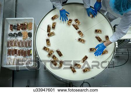 Overhead view of rotating packing line in cake factory View Large Photo Image Stock Image - Overhead view of rotating packing line in cake factory. Fotosearch