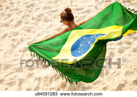 "Overhead view of young woman holding Brazilian flag whilst dancing, Ipanema beach, Rio De Janeiro, Brazil" View Large Photo Image Stock Image - "Overhead view of young woman holding Brazilian flag whilst dancing, Ipanema beach, Rio De Janeiro, Brazil". Fotosearch