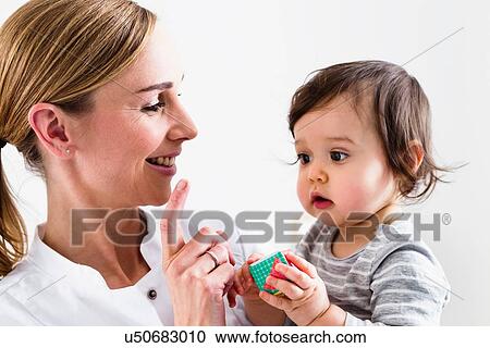 Stock Image - Paediatrician doing assessment of baby boy. Fotosearch