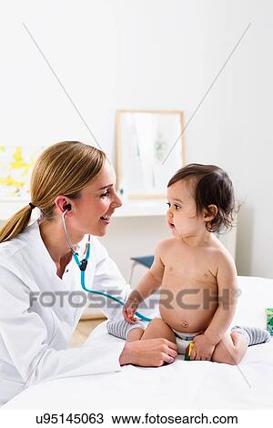 Stock Image - Paediatrician doing assessment of baby boy. Fotosearch
