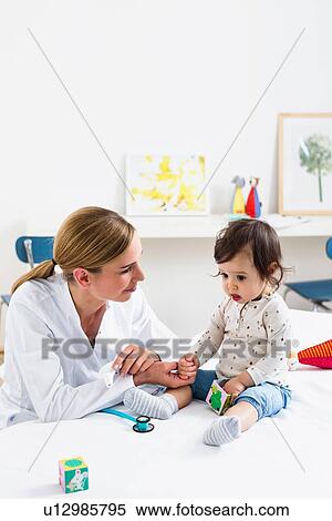 Stock Photography - Paediatrician doing assessment of baby boy. Fotosearch