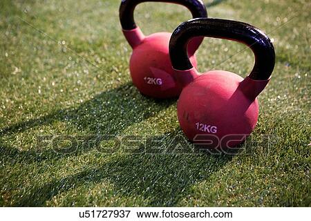 Pair of kettlebells on lawn View Large Photo Image Stock Photo - Pair of kettlebells on lawn. Fotosearch