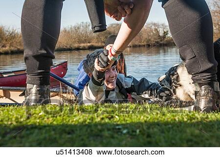 Person helping mid adult woman out from lake View Large Photo Image Stock Photo - Person helping mid adult woman out from lake. Fotosearch