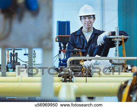 Stock Image - Portrait of apprentice engineer in power station. Fotosearch