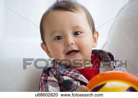 Portrait of baby boy holding toy View Large Photo Image Stock Image - Portrait of baby boy holding toy. Fotosearch
