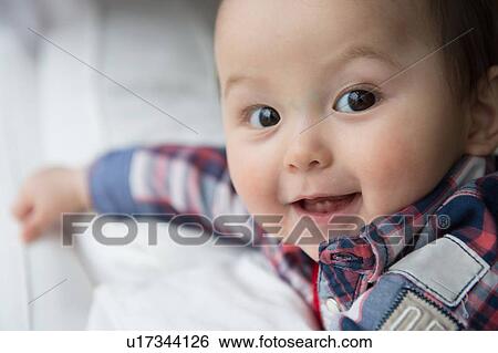 Stock Photograph - "Portrait of baby boy, looking at camera, smiling". Fotosearch