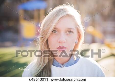 Portrait of beautiful young woman in park View Large Photo Image Stock Image - Portrait of beautiful young woman in park. Fotosearch