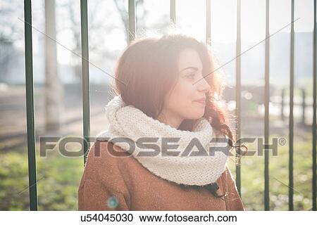 Portrait of beautiful young woman in sunlit park View Large Photo Image Stock Image - Portrait of beautiful young woman in sunlit park. Fotosearch