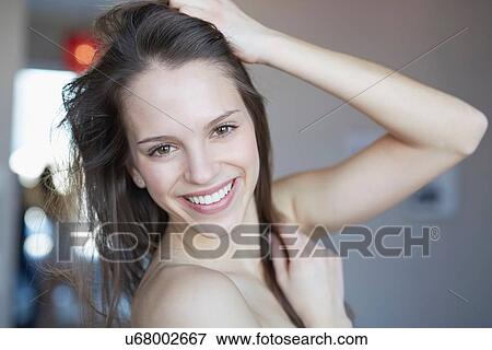 Portrait of beautiful young woman with hand in hair View Large Photo Image Stock Photo - Portrait of beautiful young woman with hand in hair. Fotosearch