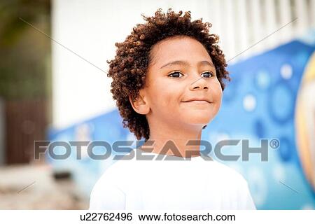 Stock Photograph - Portrait of boy at beach. Fotosearch
