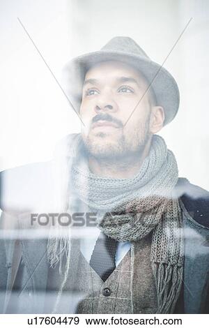 Stock Photo - Portrait of businessman behind window. Fotosearch